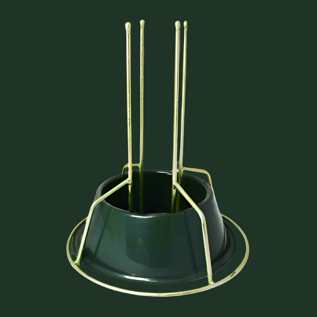 Green metal tree stand with gold-colored metal legs on a white background